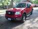 2007 Ford F-150 - 2007 Ford F-150 FX4 in red, parked outdoors on a gravel driveway.