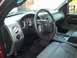 2007 Ford F-150 - The interior of a truck shows gray seats and a black steering wheel with a Ford logo.