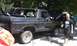 1979 Ford Bronco - This black Ford Bronco appears to be undergoing some work, with its hood up and a roll cage installed.