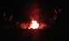 1979 Ford Bronco - A group of people gather around a bright campfire in the dark.