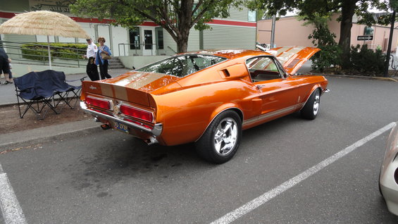 Orange 1967 Shelby GT500 with hood open, rear 3/4 view