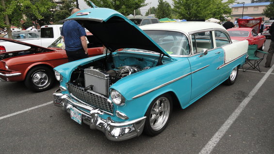 Blue and white 1955 Chevrolet Bel Air with hood open, showing engine