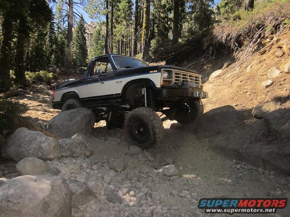Two-tone lifted Bronco navigating rocks