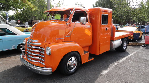 Orange flatbed truck, 3q-front view