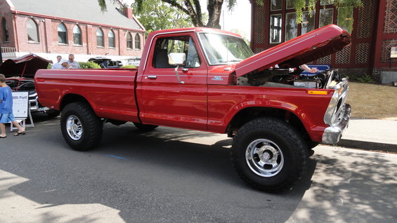 Red 1977 Ford F-150 pickup truck, 3q front view, hood open