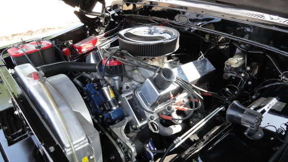 Engine bay with V8 engine, chrome air cleaner, aluminum radiator, and dual batteries