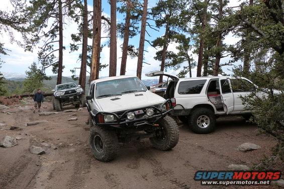 White 1996 Toyota 4Runner with off-road modifications parked on a dirt trail