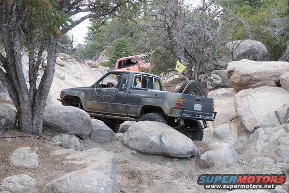 1985 Toyota 4Runner on rocky trail, spare tire mounted on rear