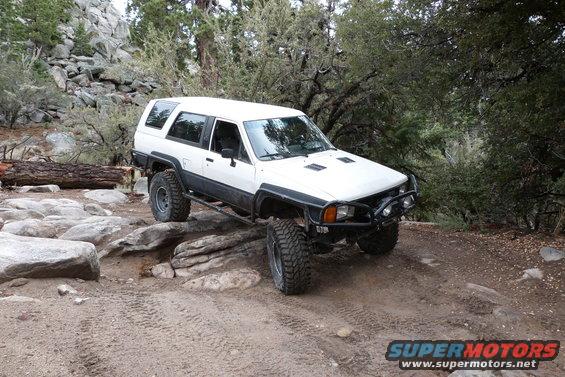 1985 Toyota 4Runner with off-road tires navigating a rocky trail