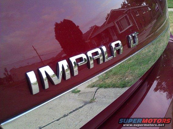 Red 2008 Chevrolet Impala rear badge with chrome trim