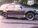 1996 Ford Bronco - This SUV has a side profile view, showing its custom wheels and roof rack.