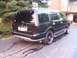 1996 Ford Bronco - This black SUV is shown from the rear three-quarter angle, with aftermarket rims and a tow hitch visible.