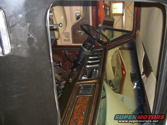 1979 Ford Bronco interior with woodgrain trim and exposed wiring