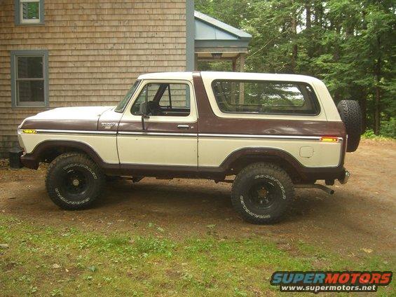 Side view of a 1979 Ford Bronco, two-tone brown and cream, with a spare tire mounted on the rear
