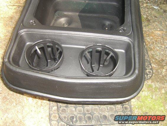 Center console part with two cup holders, possibly from an older vehicle