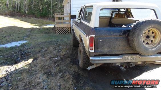 1979 Ford Bronco parked in a yard, rear view showing spare tire on tailgate