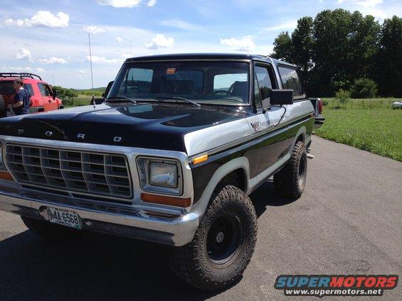 Two-tone black and silver Ford Bronco with aftermarket wheels and tires, parked on asphalt