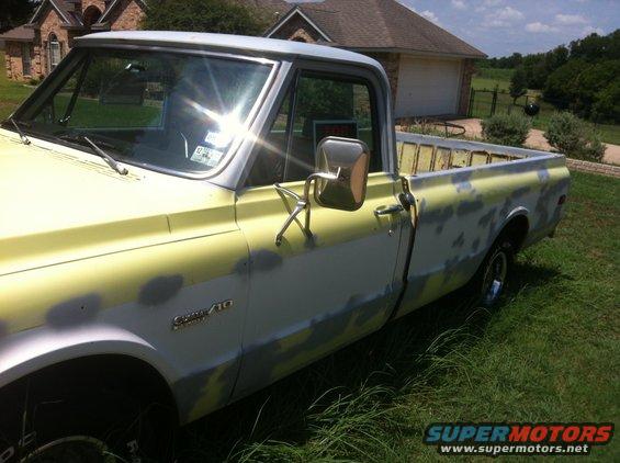 Chevrolet C/10 pickup truck, primer spots on yellow paint, parked on grass