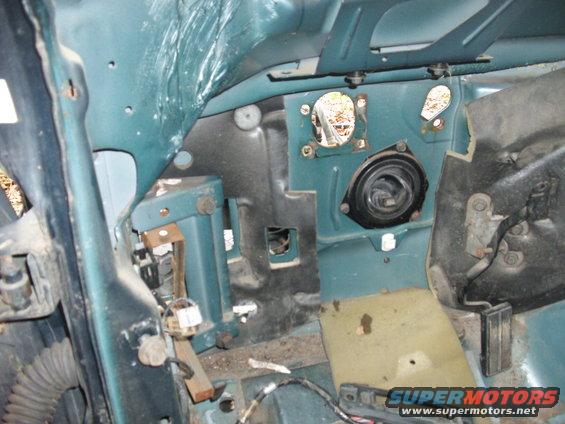 Teal interior firewall with speaker housing and exposed wiring