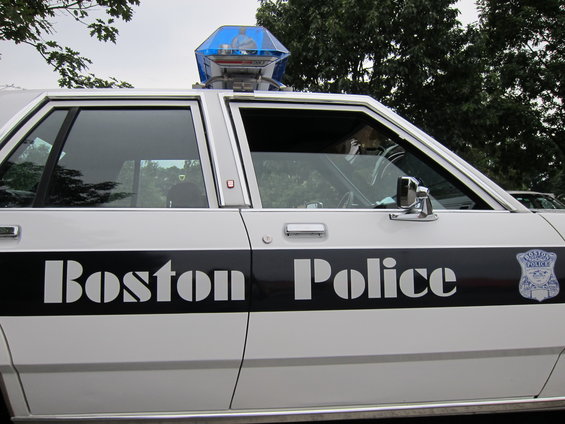 Side view of a Boston Police car with 'Boston Police' written on the door and a police badge