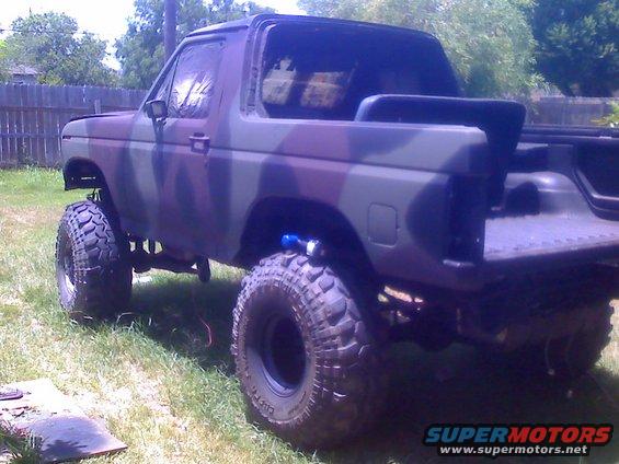 Camouflaged Ford Bronco with lifted suspension and large off-road tires