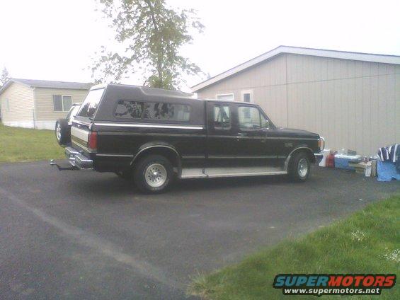 1990 Ford F-150 side view, black with camper shell