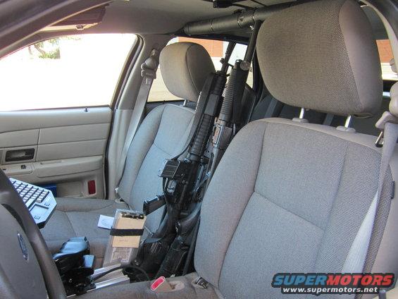 Interior view of police car with rifles between seats