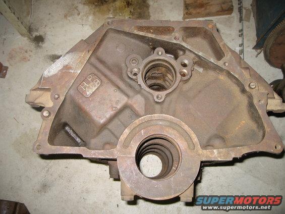 Rusty engine block with "HP 69" cast into it
