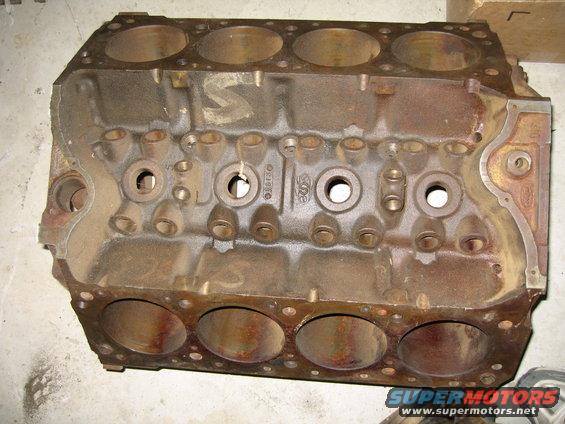 Cast iron engine block with cylinder bores visible