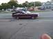 1970 Ford Ranchero - Maroon convertible cruises down the street with another car following closely behind.