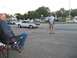 1970 Ford Ranchero - A photographer captures a classic muscle car as it cruises by, observed by a spectator.