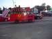 1970 Ford Ranchero - A custom fire truck float participates in a parade or event, carrying passengers and American flags.