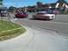 1970 Ford Ranchero - Two classic cars cruise down a suburban street on a sunny day.