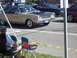 1970 Ford Ranchero - A gold 1967 Dodge Coronet with a black vinyl roof and hood scoop is seen from the front-three-quarter angle.