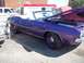 1970 Ford Ranchero - A purple convertible muscle car is parked outdoors with its hood up, next to other vehicles.
