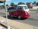 1970 Ford Ranchero - A custom Volkswagen Type 2 pickup truck with a red body and white roof is seen driving down a suburban street.