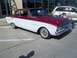 1970 Ford Ranchero - A classic two-tone Ford Falcon sedan is parked next to a modern SUV.