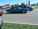 1970 Ford Ranchero - A teal 1968 Dodge Charger with a black vinyl top is seen from the side, driving alongside other vehicles.