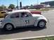 1970 Ford Ranchero - A Volkswagen Beetle, painted white with the number 53, is seen from the side.