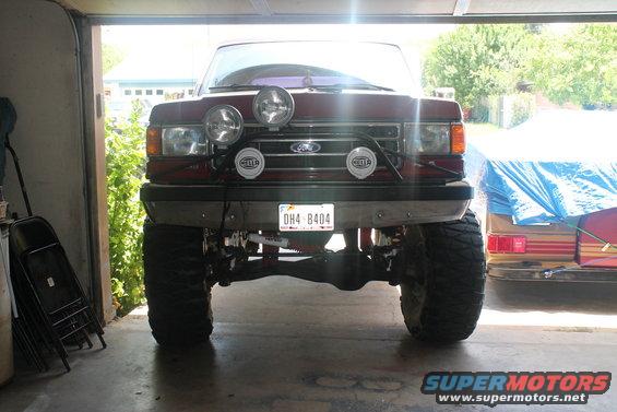 1990 Ford Bronco front view with four Hella lights mounted on a bar above the grille