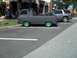 1970 Ford Ranchero - Gray 1961 Ford Econoline pickup truck with bright green wheels is parked on asphalt.