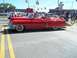1970 Ford Ranchero - A classic red 1955 Cadillac convertible is seen from the side on a sunny day.