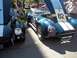 1970 Ford Ranchero - Two classic sports cars, possibly Shelby Cobras, are parked side-by-side with their hoods raised.