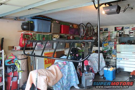 Black metal light cage hanging from garage ceiling