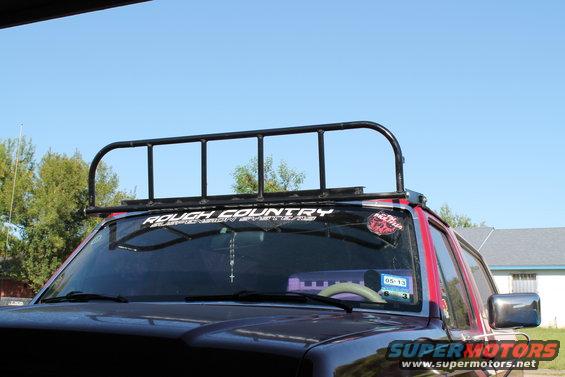 SUV front with roof rack, "ROUGH COUNTRY" sticker on windshield