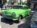 1970 Ford Ranchero - A bright green 1956 sedan is parked on a street, with another classic car visible to the right.