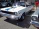 1970 Ford Ranchero - White 1970 AMC Gremlin X parked next to another car, racing stripes.