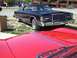 1970 Ford Ranchero - A black 1977-1979 Ford LTD II coupe is parked next to a red car.