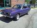 1970 Ford Ranchero - A purple Plymouth Barracuda is shown from a three-quarter front angle in front of a brick building.