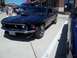 1970 Ford Ranchero - A black 1969 Ford Mustang is parked next to a blue car, with a blue truck in the background.